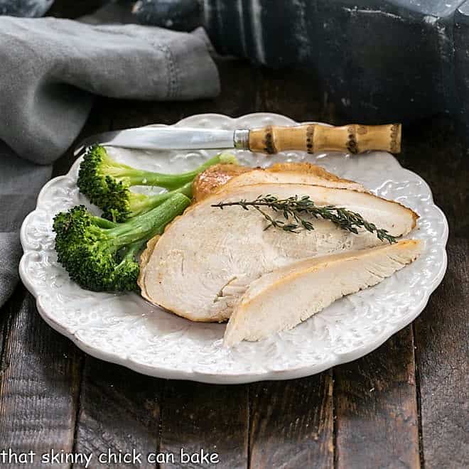 Plate of broccoli and homemade rotisserie chicken with a bamboo handle fork