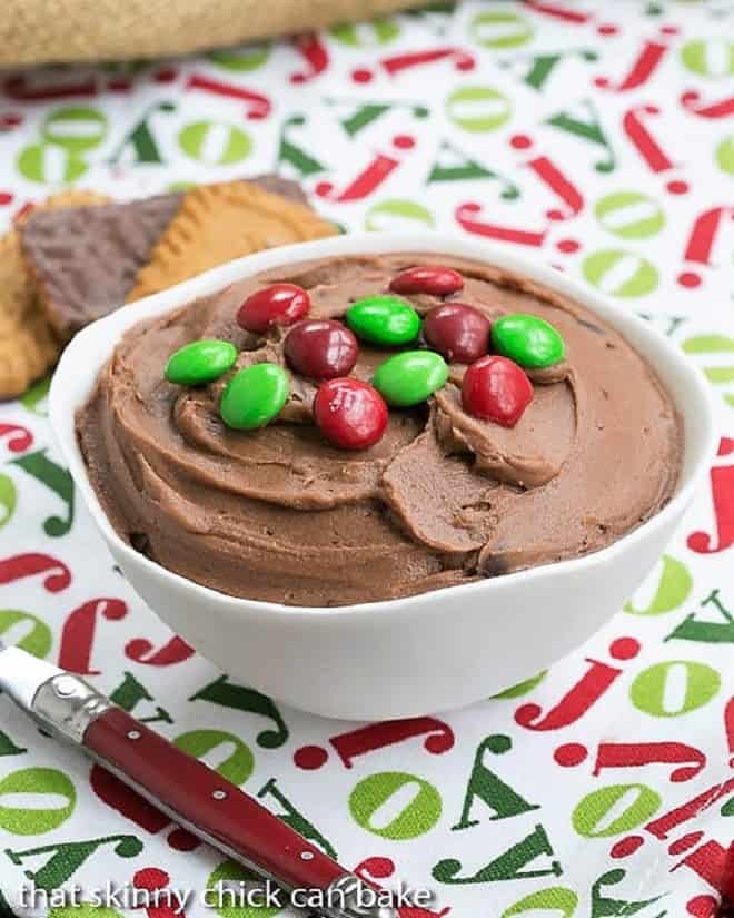 Brownie Batter Dip in a white serving bowl topped with M & M's