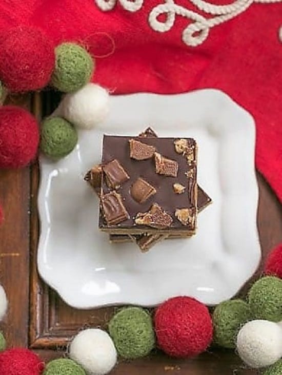 Overhead view of Candy Topped Toffee Bars on a square white plate. 