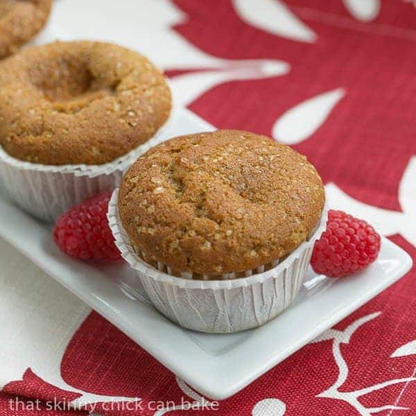 Cream Cheese Filled Pumpkin Muffins on a narrow white tray over a red and white napkin