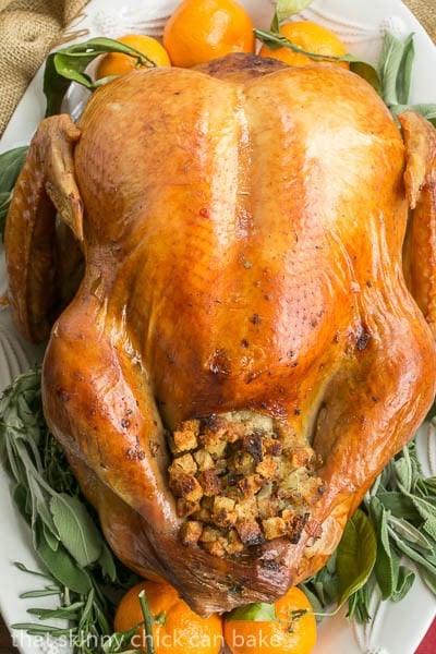 Overhead view of Dry Brined Turkey with sage, rosemary and oranges.