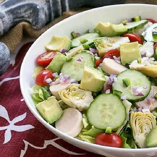 Hearts of Pam, Artichoke, Avocado and Butter Lettuce in a white serving bowl.