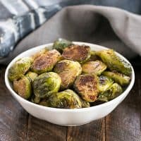 Oven Roasted Brussels Sprouts in a small white ceramic bowl