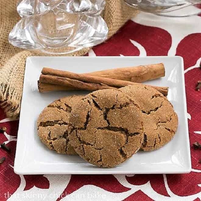 Triple Ginger Snaps with cinnamon sticks on a square white plate