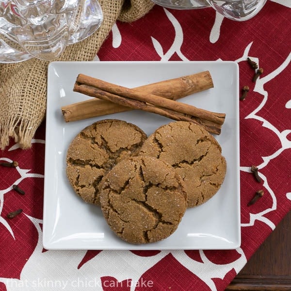 Overhead view of Triple Ginger Snaps with cinnamon sticks on a white plate