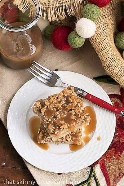 Caramel Apple Streusel Bars on a white ceramic plate with a red handled fork
