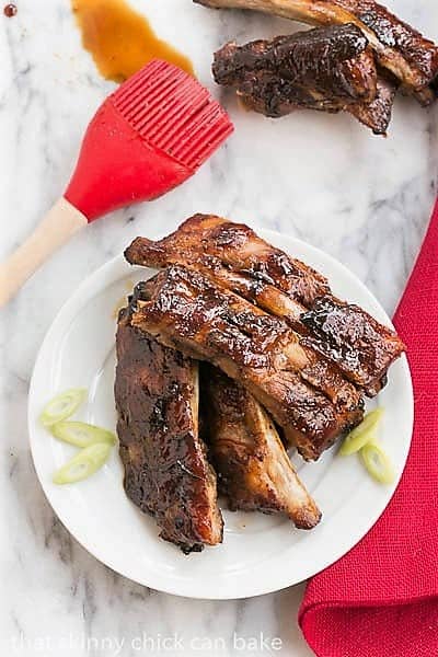 Overhead view of Oven Baked Asian Baby Back Ribs on a small white plate.