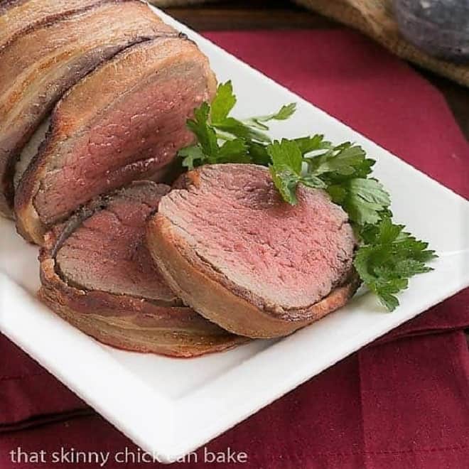 Two slices of beef tenderloin warpped in bacon.