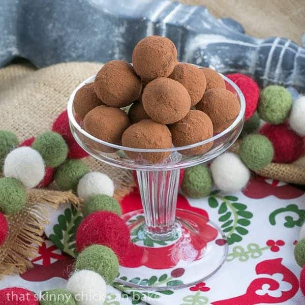 Caramel Filled Chocolate Truffles piled on a glass pedestal.