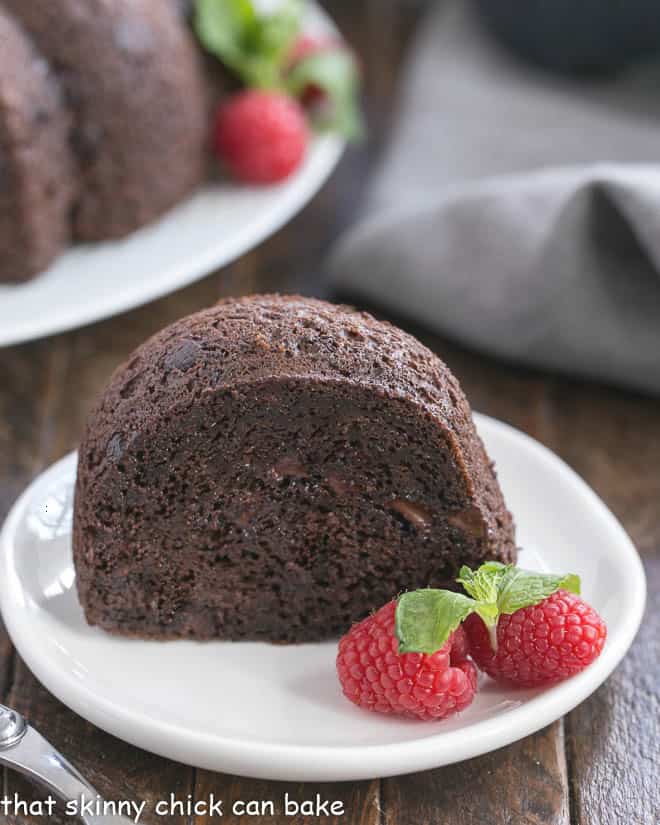 Slice of Chocolate Kahlua Cake with whole cake in the background.