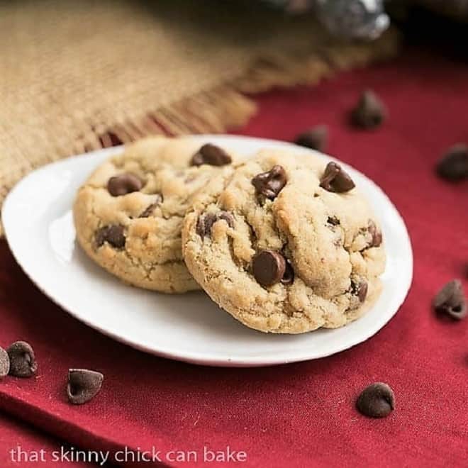 2 rum chocolate chip cookies on a white oval plate.