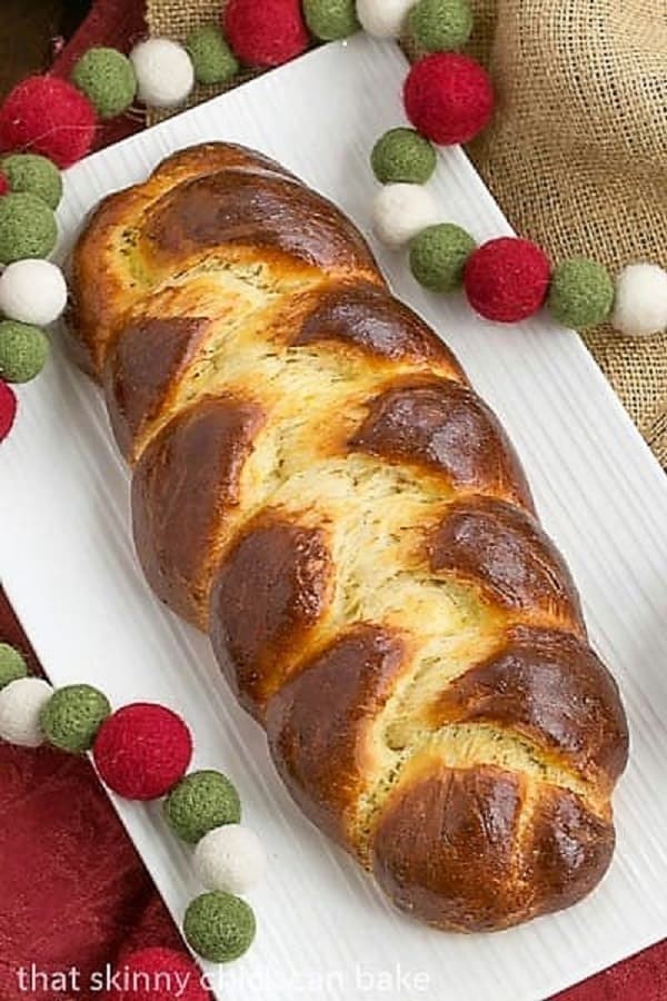 overhead view of a beautiful loaf of Swiss Butter Braid (Butterzopf) on a white platter.