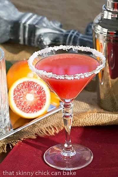 Blood Orange Margaritas in a martini glass on a red napkin