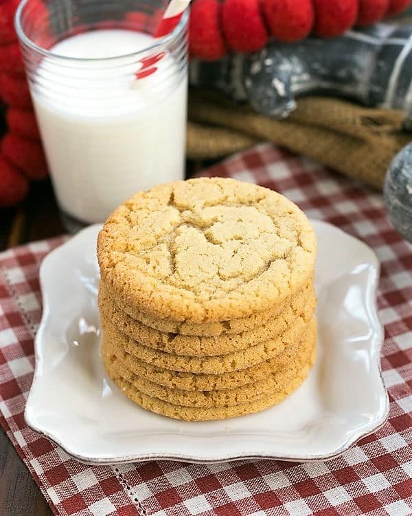 Chewy Butterscotch Cookies on a white plate with a glass of milk.