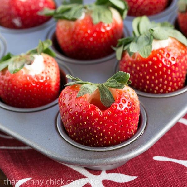 Mascarpone Filled Chocolate Covered Strawberries in a mini muffin tin ready to be filled