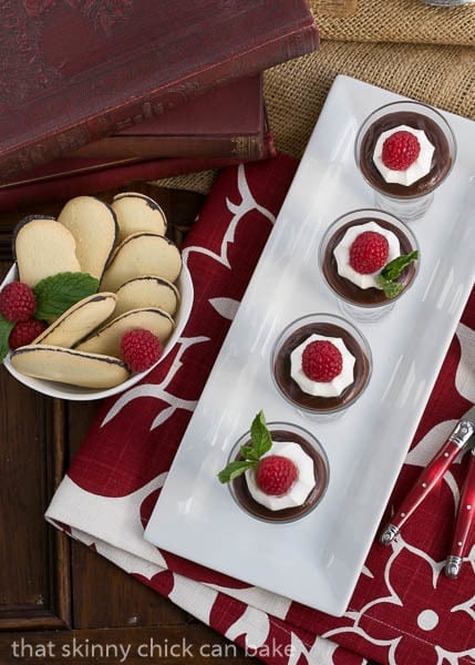 Overhead view of double Chocolate Pudding in glasses on a white rectangular tray.