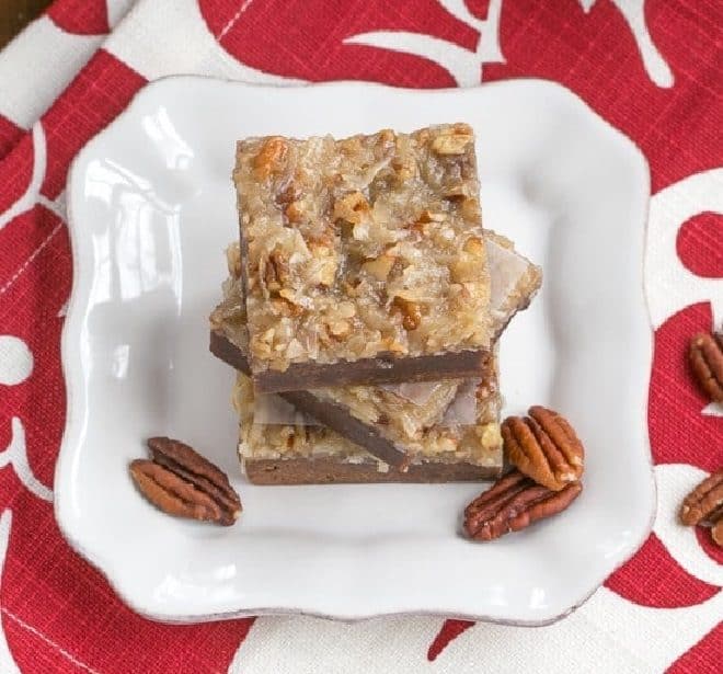 3 German Chocolate Brownies stacked on a square white plate