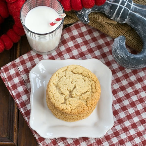 Butterscotch Cookies overhead shot on a white plate with a glass of milk on a checked napkin.