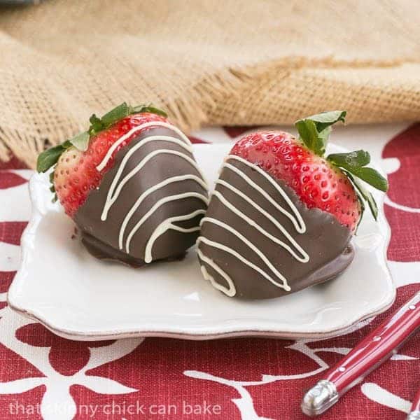 Mascarpone Filled Chocolate Covered Strawberries on a small white dessert plate