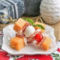 Melon and Prosciutto Skewers on a small white a