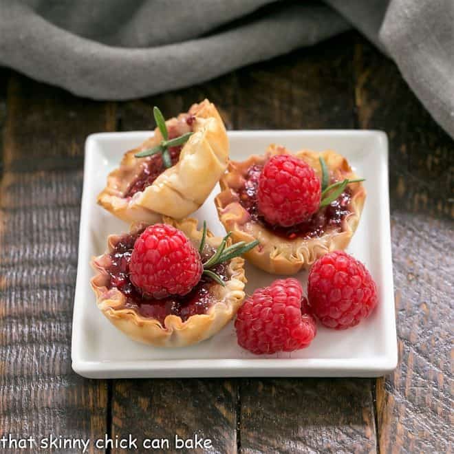 Raspberry Brie Bites  on a white a square whiteplate