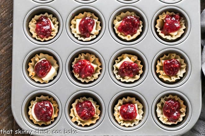 Unbaked Brie appetizers in a muffin tin