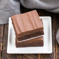 Frosted Brownies Recipe stacked on a small white plate
