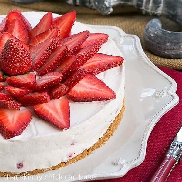 Strawberry Vanilla Cream Pie close view of half the pie on a serving dish.