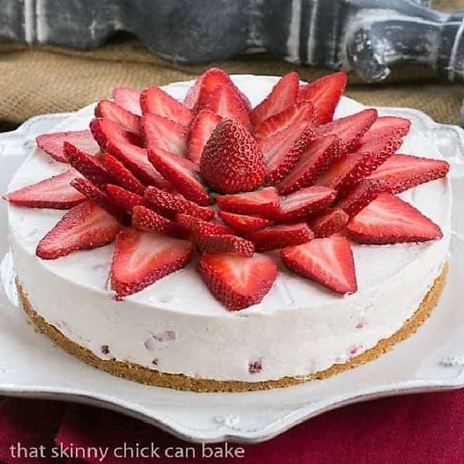 Strawberry Vanilla Cream Pie topped with fresh strawberry slices on a white Juliska serving plate.