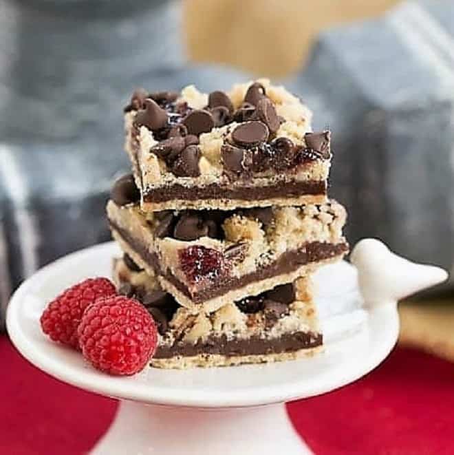 Chocolate Raspberry Crumb Bars on a small white pedestal