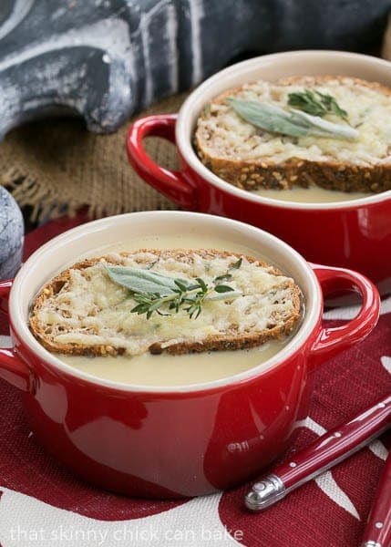 Hangover Soup topped with cheesy toasts and herbs.