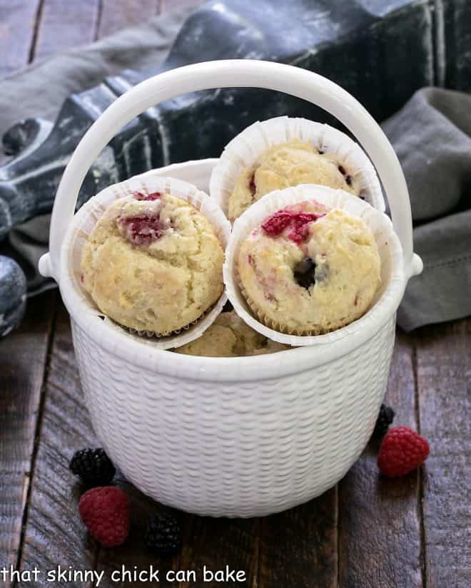 Berry Sour Cream Muffins in a ceramic basket.