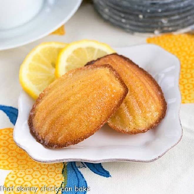 Lemon Madeleines on a small white plate with lemon slices