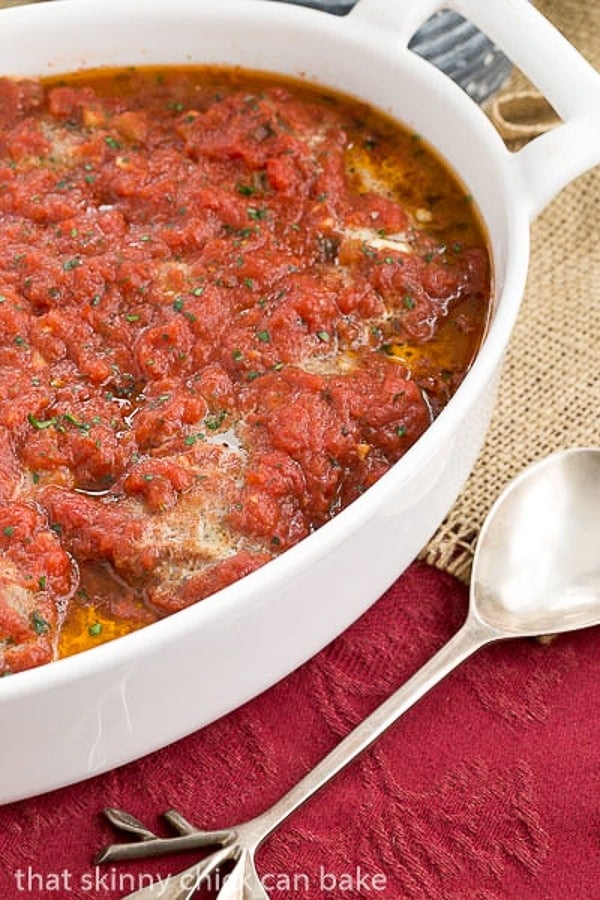 Mozzarella Stuffed Meatballs in a white casserole dish.