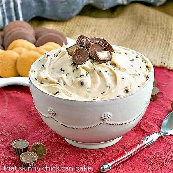 Peanut Butter Tagalong Dip in a ceramic bowl with a red handled spoon