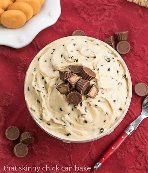 Overhead view of Tagalong dip in a serving bowl topped with mini Reeses peanut butter cups