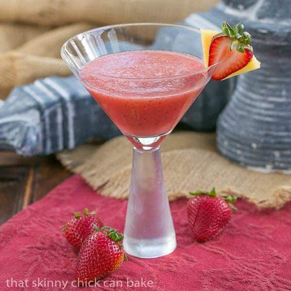 Hawaiian Sunset Cocktail garnished with a strawberry and pineapple slice