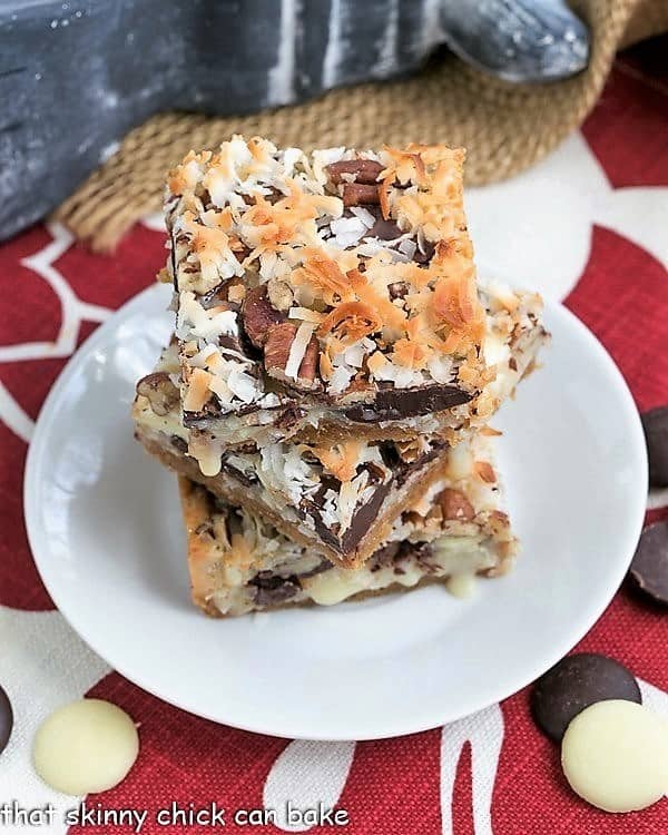 The Best Seven Layer Bars stacked on a round white plate.