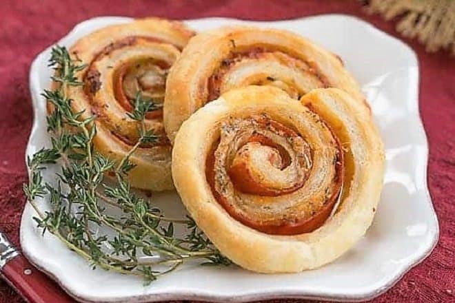 Honey Mustard Pepperoni Pinwheels on a square white plate garnished with thyme