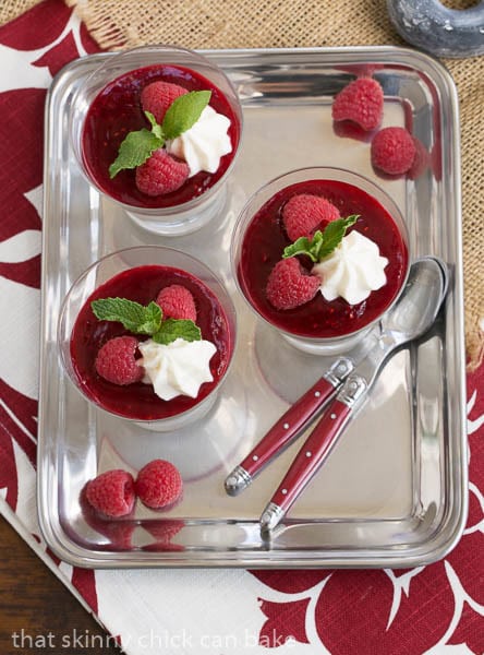 Overhead view of Raspberry White Chocolate Cheesecake Parfaits on a silver tray