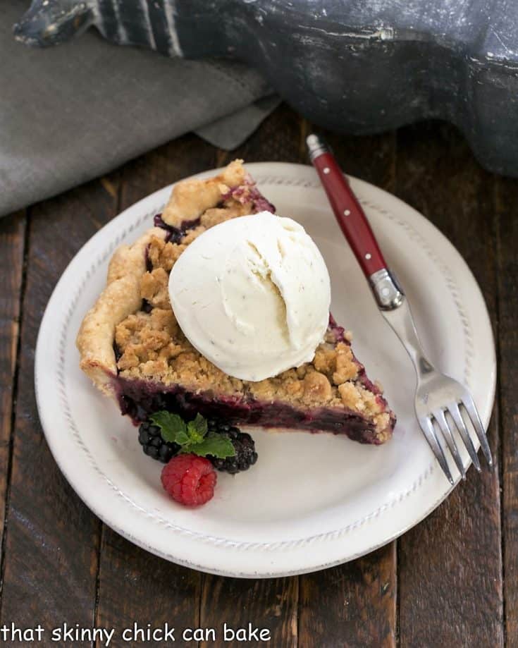 Overhead slice of razzleberry pie ala mode with a scoop of vanilla ice cream