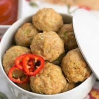 Sesame Ginger Meatballs in a white lidded serving dish