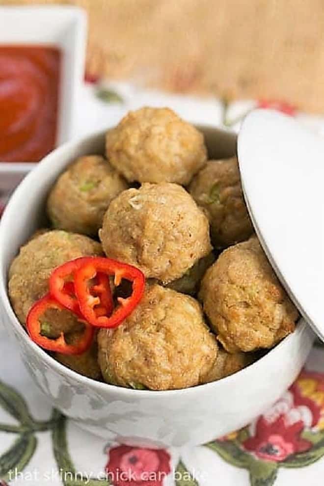 Sesame Ginger Meatballs in a white lidded serving dish