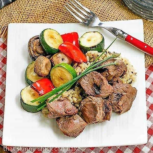 Beef Teriyaki Kabobs - Tender grilled beef and veggies flavored with an Asian marinade Beef Teriyaki Kabobs on a square white plate