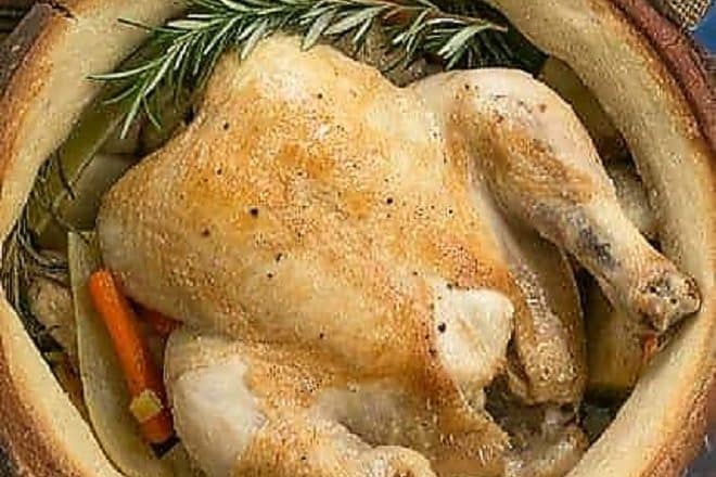 Chicken in a Pot from above cooked in a blue Dutch oven