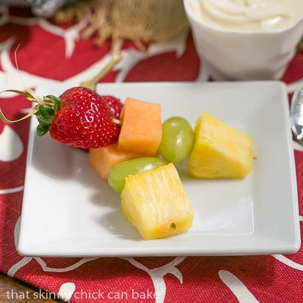 Two Fruit Kebabs with White Chocolate Mascarpone Dip on a square white plate