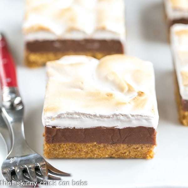 S'mores Fudge Bars on a white platter with 2 red handled forks