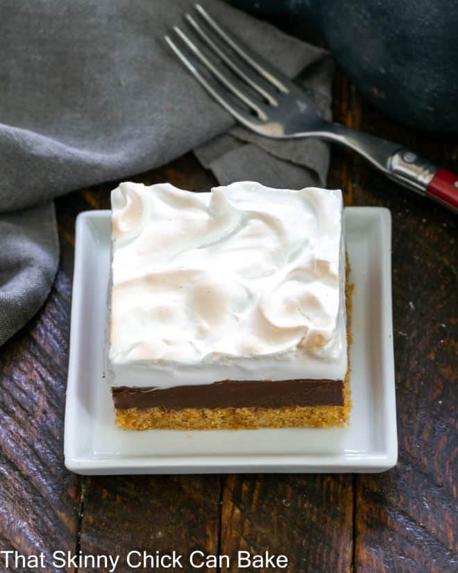 A S'mores Fudge Bar on a small white square ceramic plate.