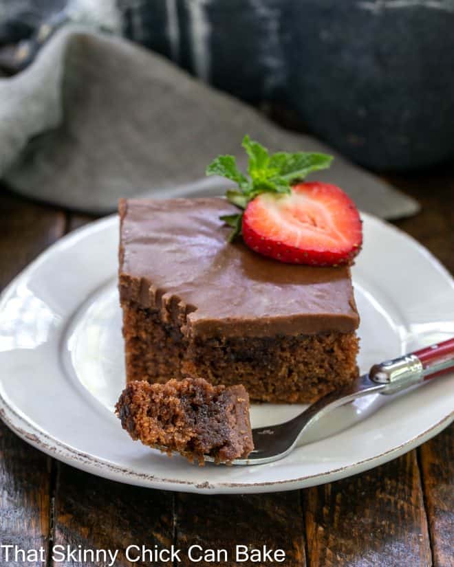coca cola cake with a bite removed on a red handled fork