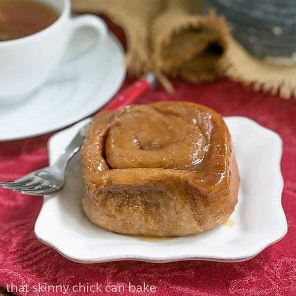 Cinnamon Sticky Buns on a white plate with a red handled fork